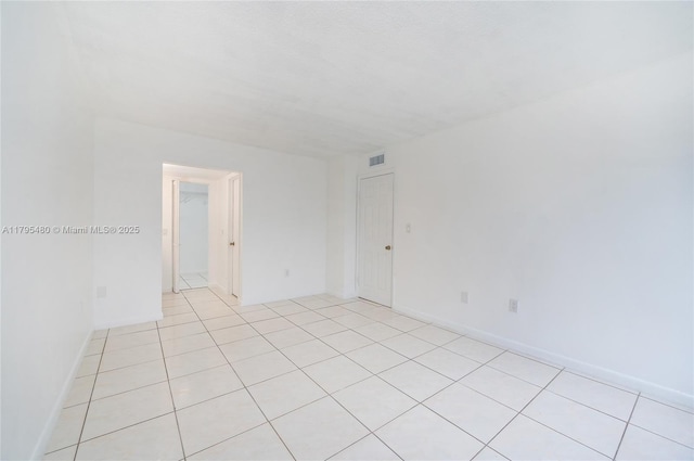 unfurnished room with light tile patterned floors and visible vents
