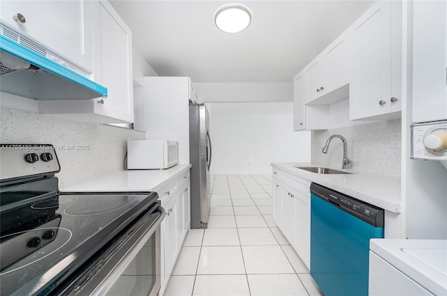 kitchen featuring light tile patterned flooring, appliances with stainless steel finishes, a sink, light countertops, and under cabinet range hood
