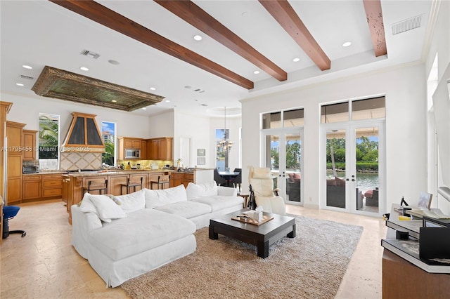 living area featuring french doors, crown molding, beam ceiling, recessed lighting, and a high ceiling