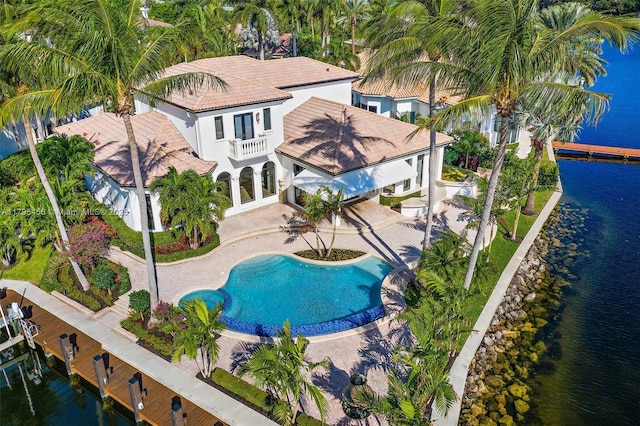 view from above of property featuring a nearby body of water and a pool