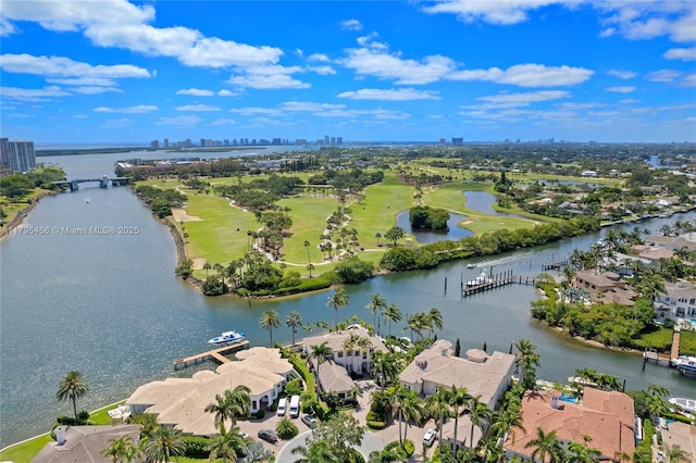 aerial view of residential area with a nearby body of water, a skyline view, and a golf club