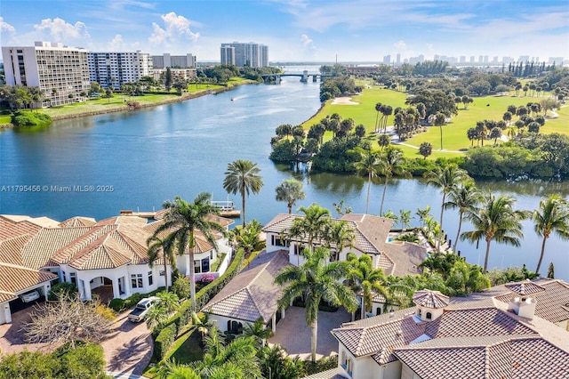 view of urban area with a nearby body of water and a golf course