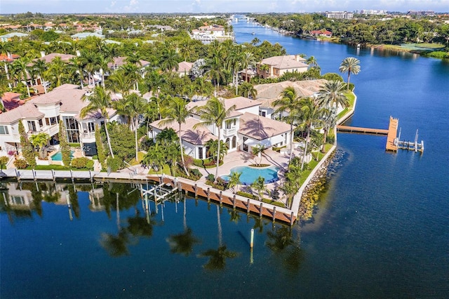 drone / aerial view of a nearby body of water and a pool