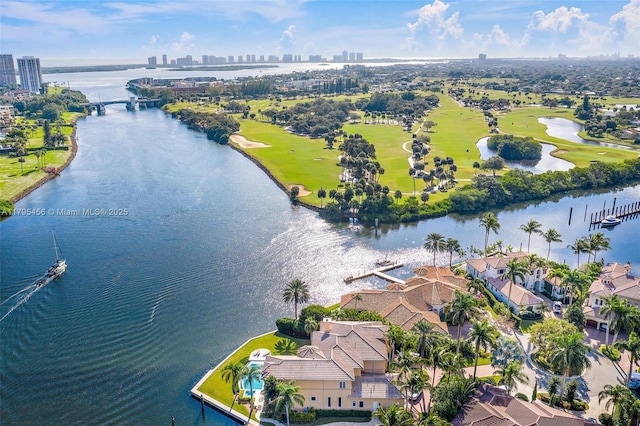 view of urban area with a large body of water and a golf club