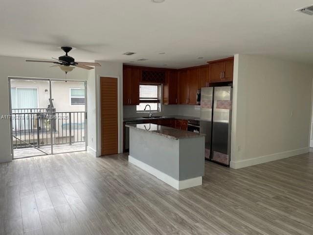 5209 NW 18th St Unit 3E, Lauderhill, FL 33313 - kitchen featuring a ceiling fan, visible vents, baseboards, freestanding refrigerator, and light wood-style flooring