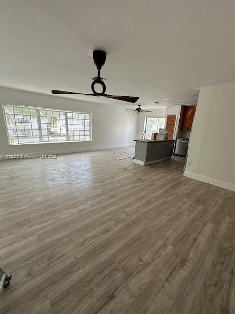 5209 NW 18th St Unit 3E, Lauderhill, FL 33313 - unfurnished living room featuring ceiling fan, dark wood finished floors, and baseboards