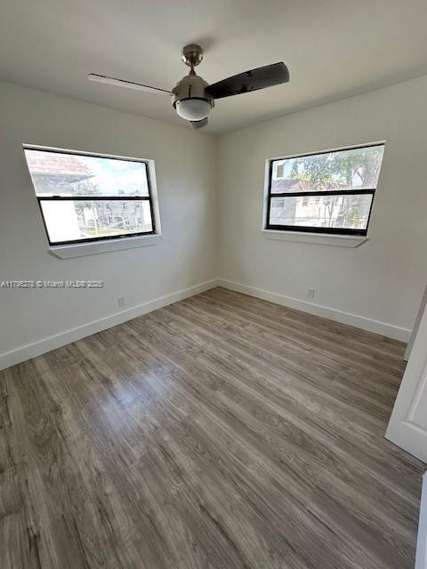 5209 NW 18th St Unit 3E, Lauderhill, FL 33313 - spare room featuring baseboards, ceiling fan, and wood finished floors