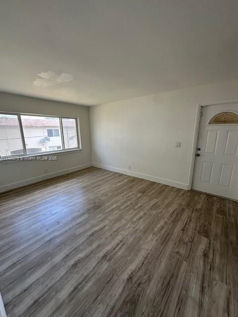 5209 NW 18th St Unit 3E, Lauderhill, FL 33313 - unfurnished room with baseboards and dark wood-type flooring