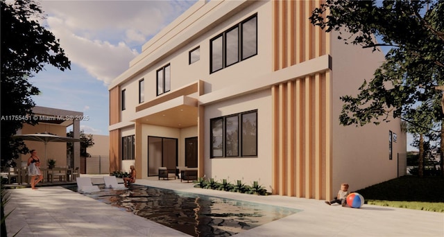 back of property featuring a patio and stucco siding