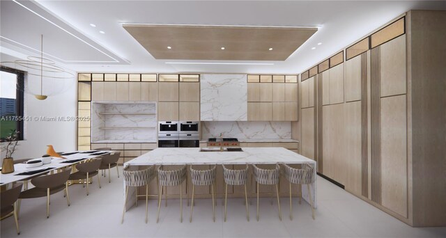 kitchen featuring modern cabinets, light brown cabinetry, light stone countertops, and a kitchen bar