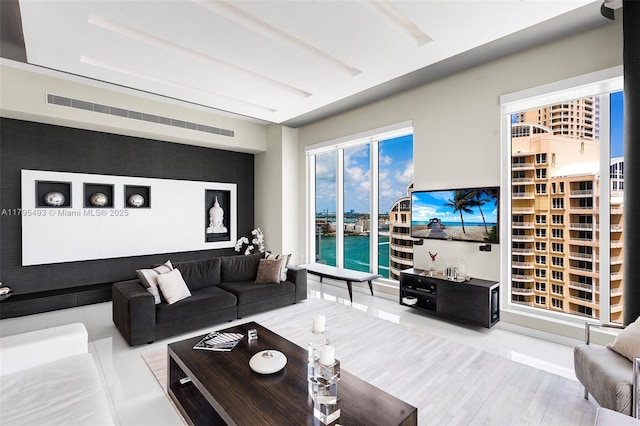living room with visible vents and wood finished floors
