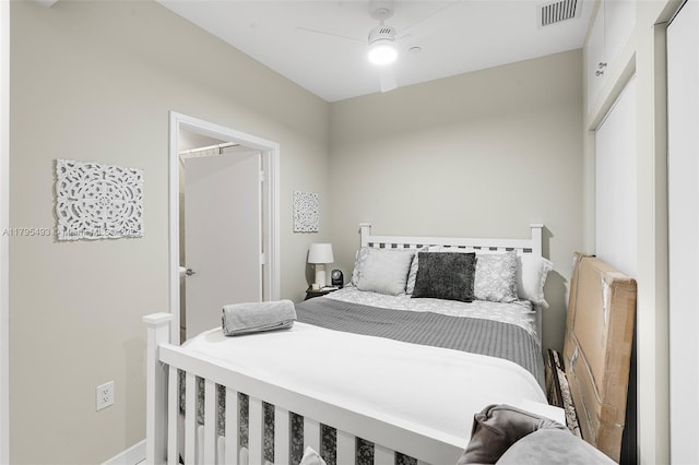 bedroom featuring ceiling fan, visible vents, and baseboards