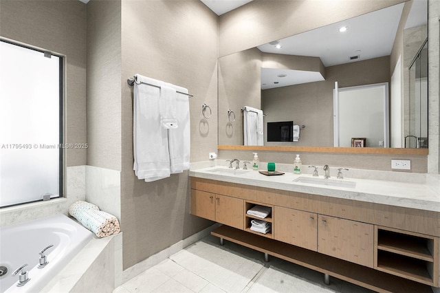 full bathroom featuring a garden tub, a sink, a stall shower, and double vanity