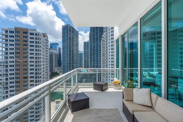 balcony with a city view and outdoor lounge area