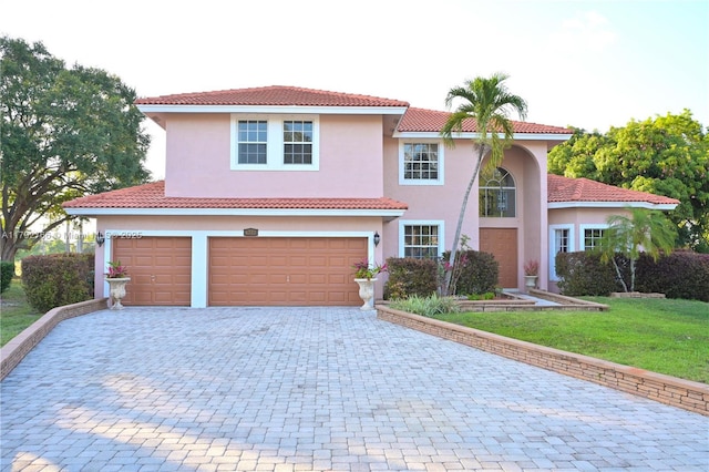 6777 NW 44th Ct, Coral Springs, FL 33067 - view of front of property with a front lawn, stucco siding, an attached garage, and decorative driveway