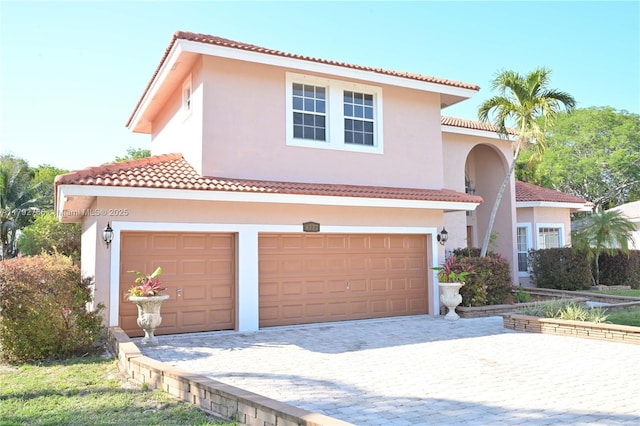 6777 NW 44th Ct, Coral Springs, FL 33067 - mediterranean / spanish-style home featuring an attached garage, a tiled roof, decorative driveway, and stucco siding