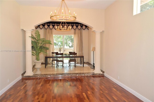 6777 NW 44th Ct, Coral Springs, FL 33067 - dining area featuring baseboards, a chandelier, ornate columns, and wood finished floors
