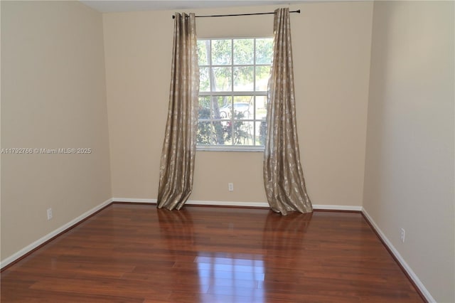 6777 NW 44th Ct, Coral Springs, FL 33067 - spare room with baseboards, a healthy amount of sunlight, and wood finished floors