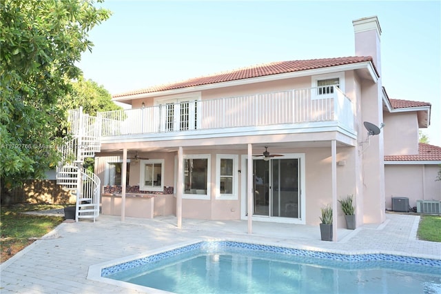 6777 NW 44th Ct, Coral Springs, FL 33067 - back of house featuring central AC unit, stairway, stucco siding, and ceiling fan