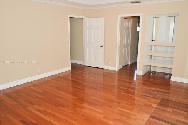 6777 NW 44th Ct, Coral Springs, FL 33067 - empty room featuring crown molding, baseboards, visible vents, and wood finished floors