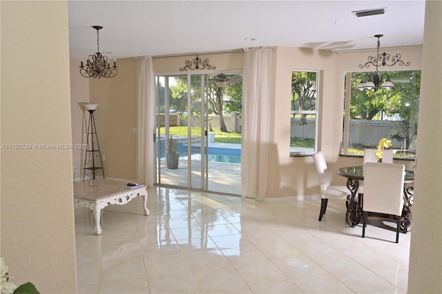 6777 NW 44th Ct, Coral Springs, FL 33067 - doorway with a chandelier, tile patterned floors, a healthy amount of sunlight, and visible vents