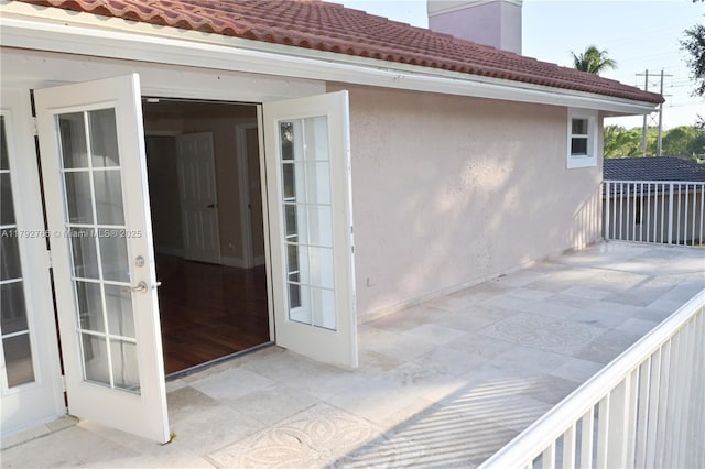 6777 NW 44th Ct, Coral Springs, FL 33067 - doorway to property with a patio, stucco siding, a chimney, and a tiled roof