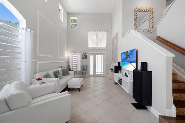 2093 NW 208th Ter, Pembroke Pines, FL 33029 - living area featuring light tile patterned flooring, baseboards, stairway, and a towering ceiling