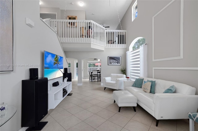 2093 NW 208th Ter, Pembroke Pines, FL 33029 - living room featuring light tile patterned floors, arched walkways, and a towering ceiling