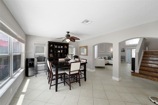 2093 NW 208th Ter, Pembroke Pines, FL 33029 - dining space featuring a ceiling fan, visible vents, arched walkways, stairway, and light tile patterned floors