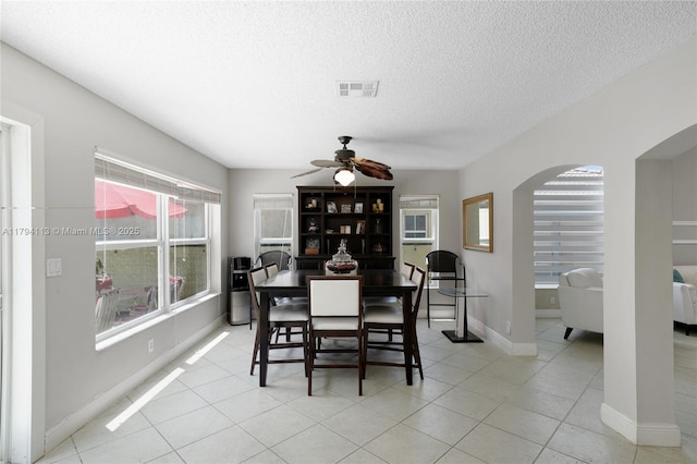 2093 NW 208th Ter, Pembroke Pines, FL 33029 - dining area with light tile patterned flooring, arched walkways, a textured ceiling, a ceiling fan, and visible vents