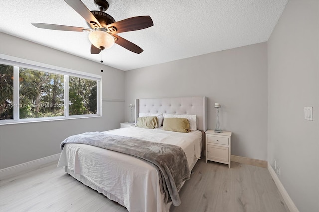 2093 NW 208th Ter, Pembroke Pines, FL 33029 - bedroom featuring baseboards, a textured ceiling, and light wood-style flooring