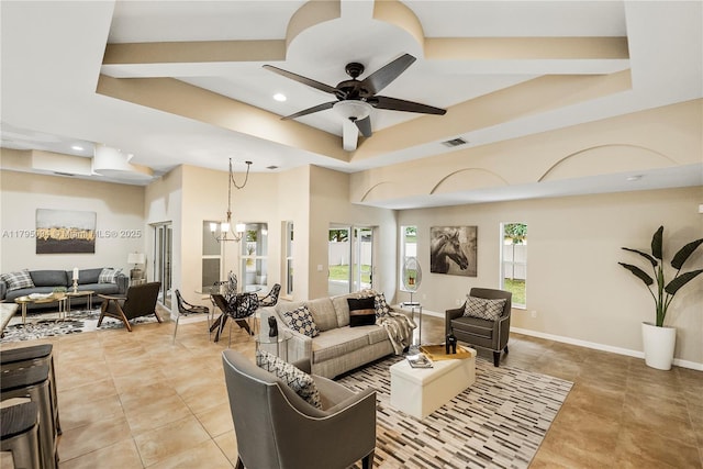 living room with visible vents, light tile patterned floors, ceiling fan with notable chandelier, a tray ceiling, and recessed lighting