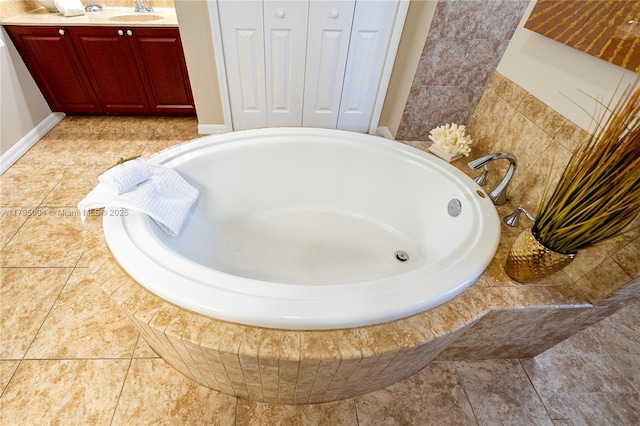 bathroom with vanity and a bath
