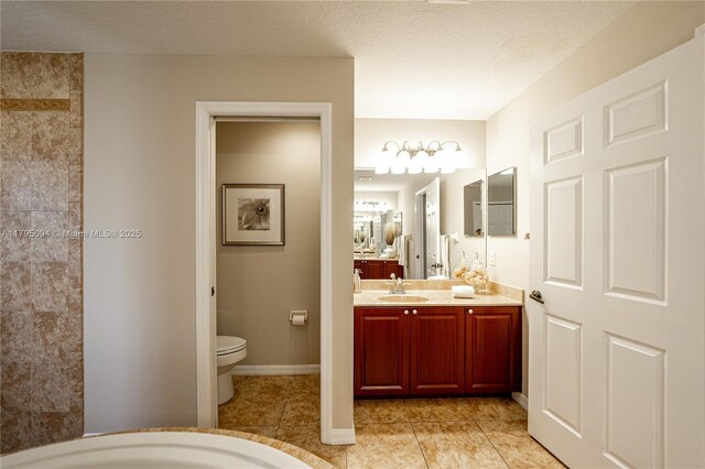 full bath with toilet, a textured ceiling, tile patterned flooring, and vanity