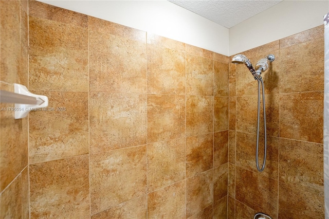 room details with a tile shower and a textured ceiling