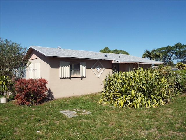 view of property exterior with a lawn and stucco siding