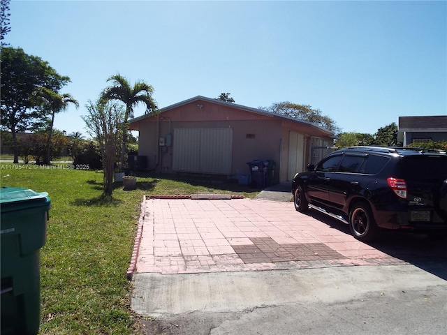 view of home's exterior featuring a lawn and an outdoor structure