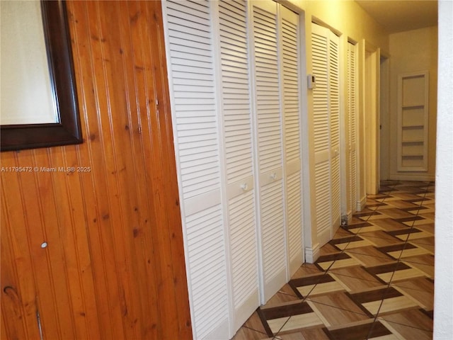 hall featuring wood walls