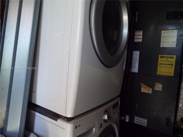 clothes washing area featuring laundry area and stacked washer / drying machine