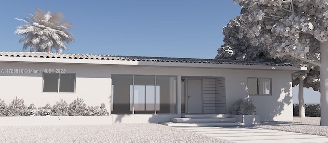 back of property featuring stucco siding