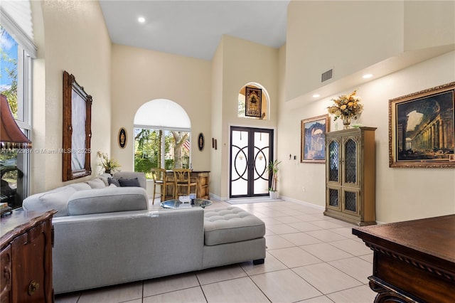 11613 NW 11th Pl, Coral Springs, FL 33071 - living area featuring baseboards, a high ceiling, visible vents, and light tile patterned floors