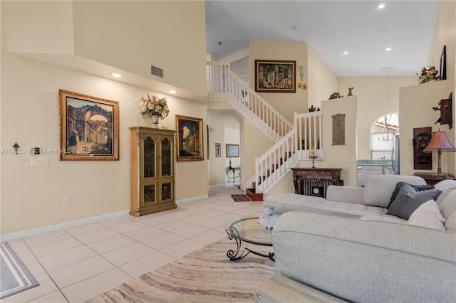 11613 NW 11th Pl, Coral Springs, FL 33071 - living room with stairs, a high ceiling, visible vents, and light tile patterned floors
