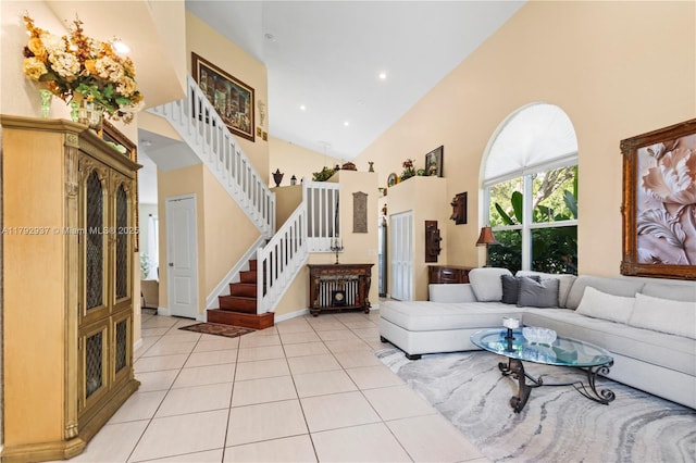 11613 NW 11th Pl, Coral Springs, FL 33071 - living room featuring stairs, high vaulted ceiling, baseboards, and light tile patterned floors