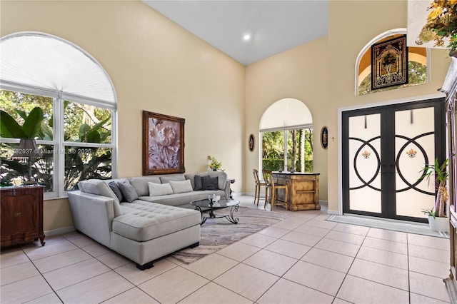 11613 NW 11th Pl, Coral Springs, FL 33071 - living room with light tile patterned floors, a high ceiling, and french doors
