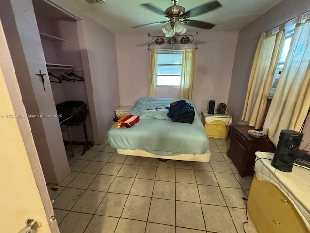 bedroom featuring ceiling fan, visible vents, and light tile patterned floors