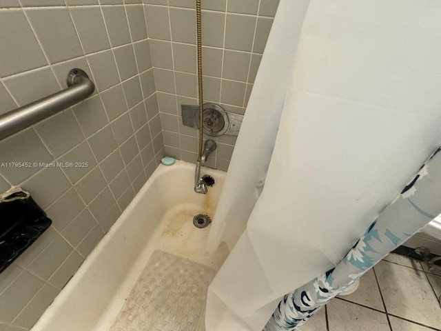 bathroom with tile patterned floors and shower / tub combo