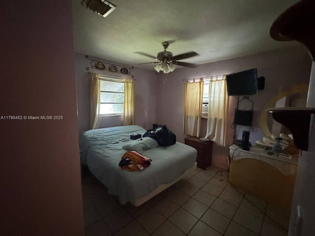 bedroom with a ceiling fan and light tile patterned floors