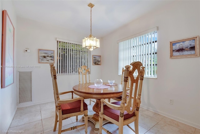 dining room featuring light tile patterned floors, baseboards, visible vents, and an inviting chandelier