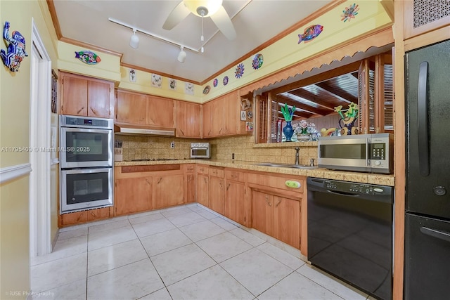kitchen featuring ceiling fan, track lighting, light countertops, under cabinet range hood, and black appliances