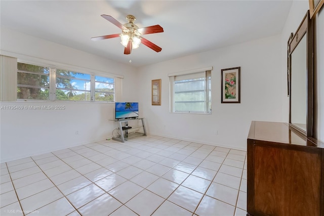 spare room with light tile patterned flooring and ceiling fan